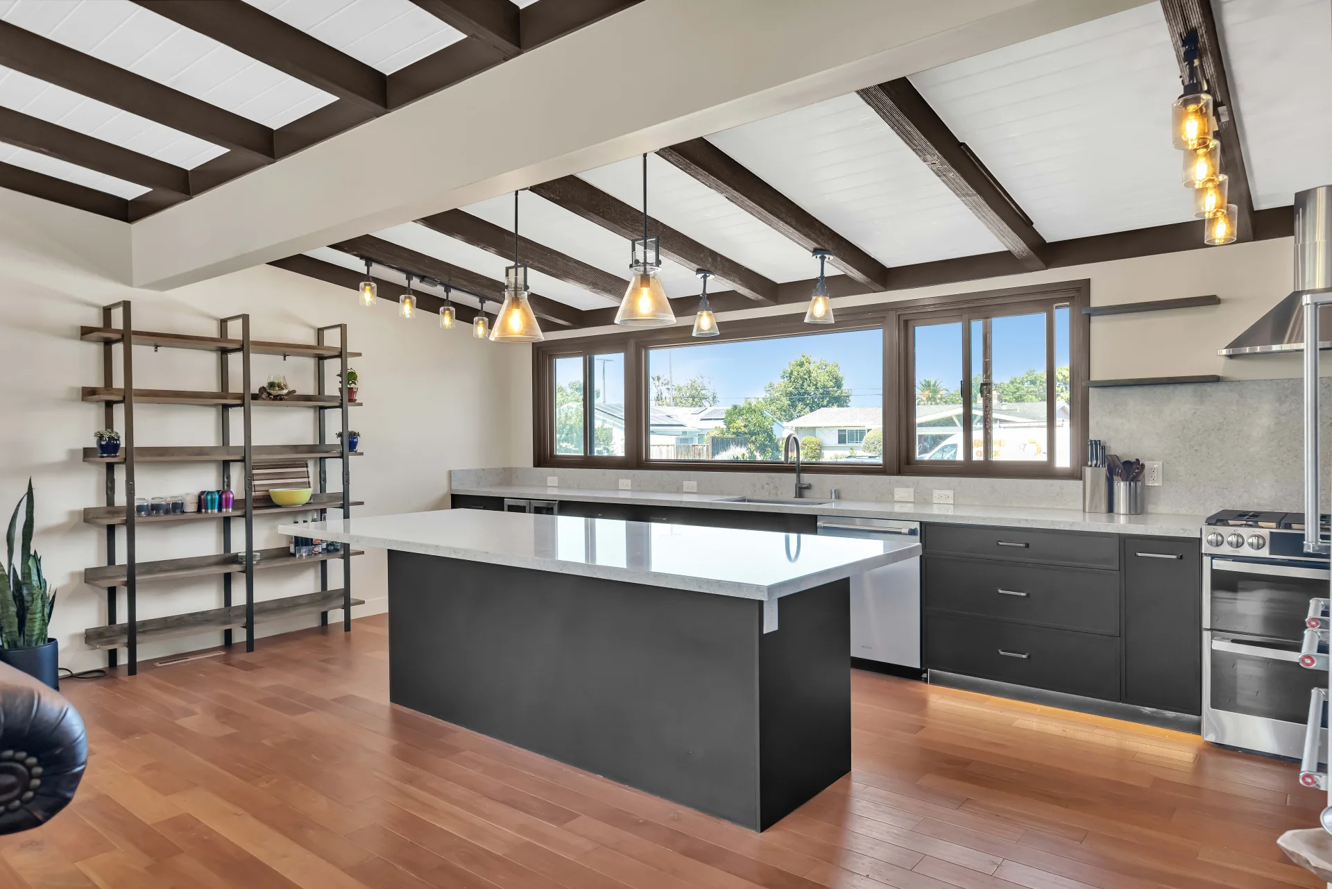 Santa Clara modern kitchen remodel — dark cabinets, quartz countertops, exposed beams by Inspired Builders