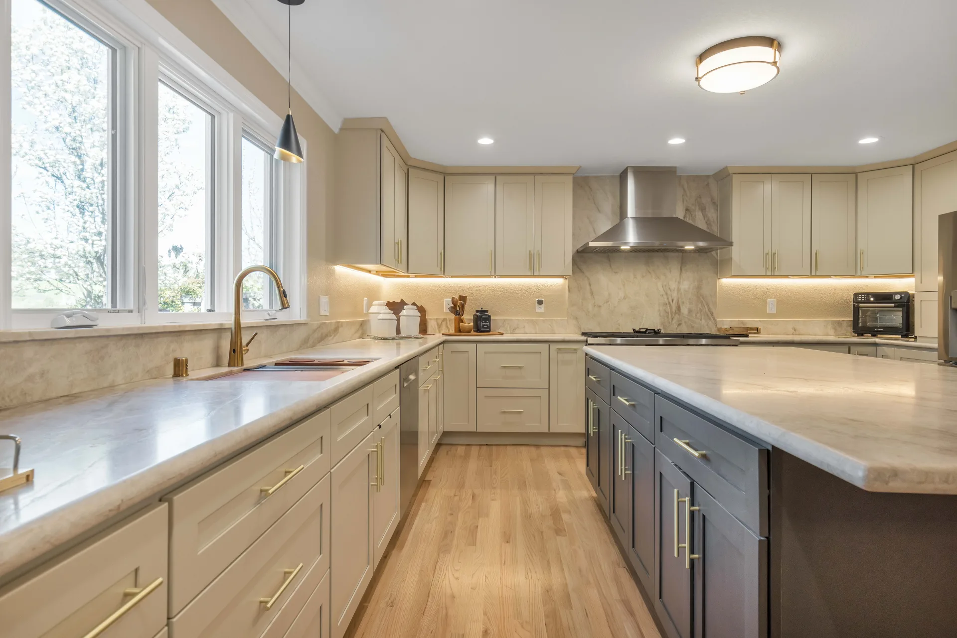 Danville kitchen remodel with natural light — waterfall island, under-cabinet lighting by Inspired Builders