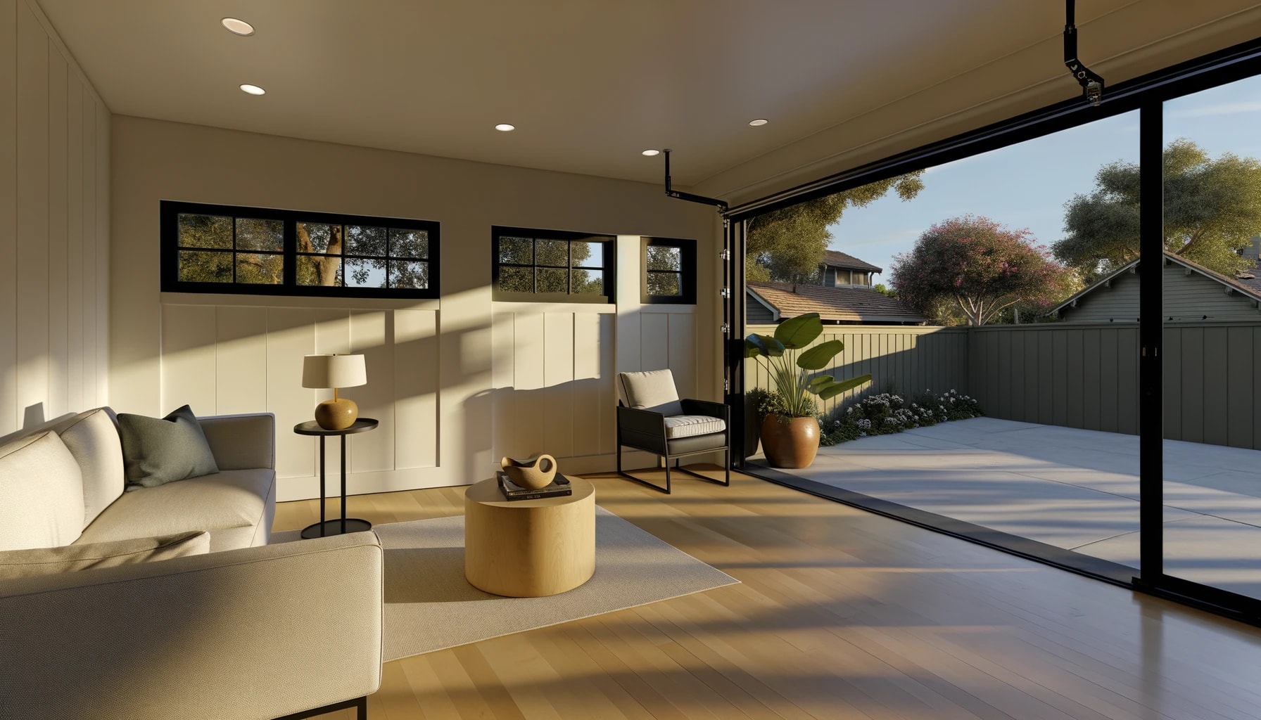 Garage converted to a warm, light-filled living space with sliding glass doors to a private patio