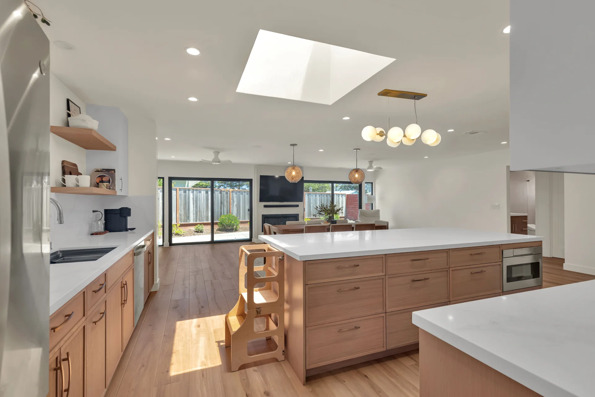 San Bruno farmhouse kitchen remodel — open concept, globe pendants, skylight by Inspired Builders